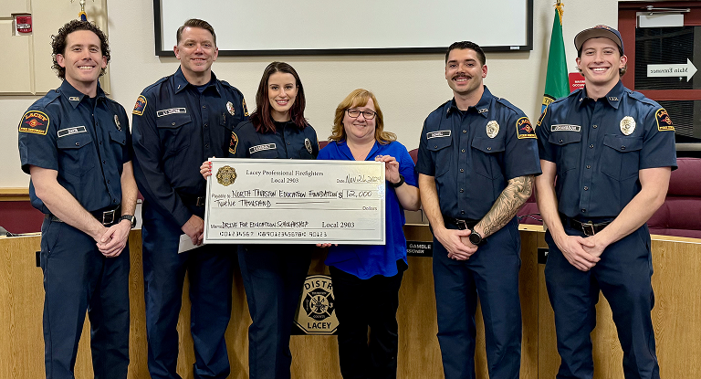 Fire department personnel with check